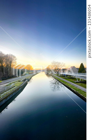 Enjoy the serene beauty of Twilight over a tranquil river landscape in perfect harmony Enjoy the serene beauty of Twilight over a tranquil river landscape in perfect harmony 131486054