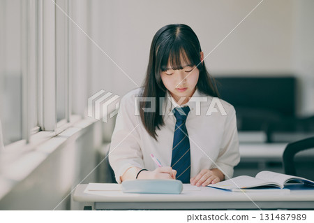 Female junior high school student studying in a cram school classroom Female junior high school student studying in a cram school classroom 131487989