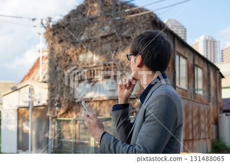 Man looking at an empty house 131488065