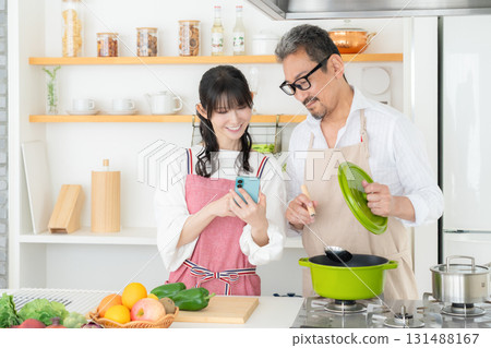 Middle-aged couple cooking in the kitchen Middle-aged couple cooking in the kitchen 131488167