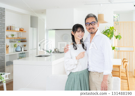 A middle-aged couple relaxing in the living room A middle-aged couple relaxing in the living room 131488190