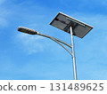 Street light powered by solar panel against clear blue sky, showcasing renewable energy technology, sustainable urban infrastructure, and eco-friendly outdoor lighting solution 131489625