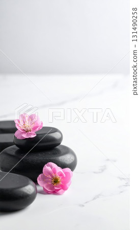 Pink flower, zen stones on marble table 131490258
