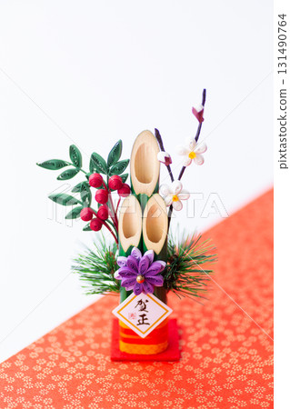 New Year's pine decoration on a red and white background New Year's pine decoration on a red and white background 131490764
