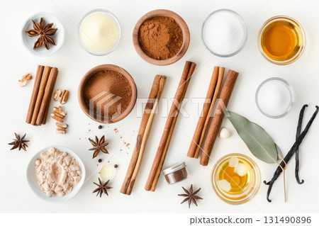 Various spices, including cinnamon sticks and star anise, create a cozy autumnal atmosphere on a table, inviting warmth and flavor 131490896