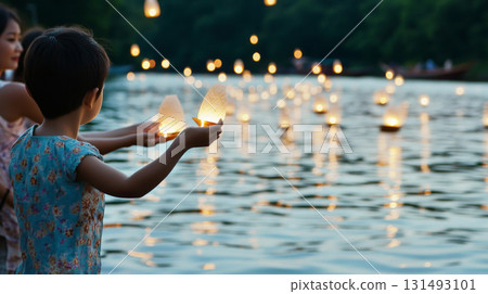 Yi Peng festival showing river lanterns and people at twilight, background Yi Peng festival showing river lanterns and people at twilight, background 131493101