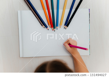 Little girl drawing greeting card on table. Father's day concept Little girl drawing greeting card on table. Father's day concept 131494027
