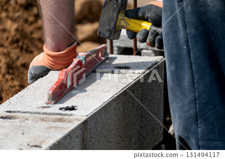 Handyman working on a construction site with tools 131494117