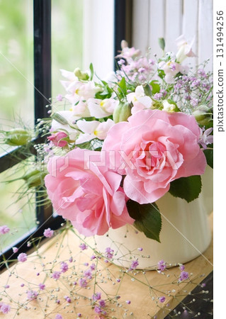 Pink rose on the windowsill 131494256