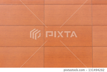 Brown wooden wall paneling with visible screws and geometric rectangular pattern. Modern architectural cladding texture suitable for construction, design backgrounds, architectural details Brown wooden wall paneling with visible screws and geometric rectangular pattern. Modern architectural cladding texture suitable for construction, design backgrounds, architectural details 131494282