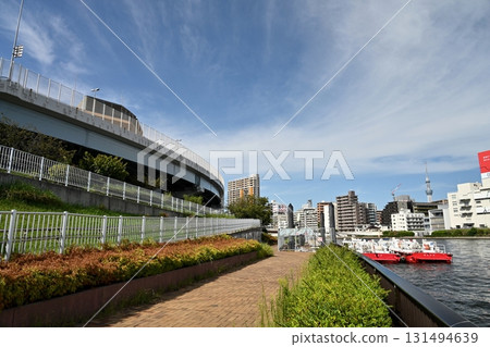 Sumida River in early autumn. A moored fireboat and the wide blue autumn sky. 131494639