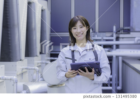 Smiling young female worker holding a tablet. Photo courtesy of Denpa Gakuen Tokyo Electronics College. Smiling young female worker holding a tablet. Photo courtesy of Denpa Gakuen Tokyo Electronics College. 131495380
