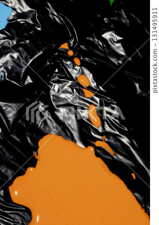 Mixed up wet acrylic colored paint on black plastic background abstract background style splatter 131495911