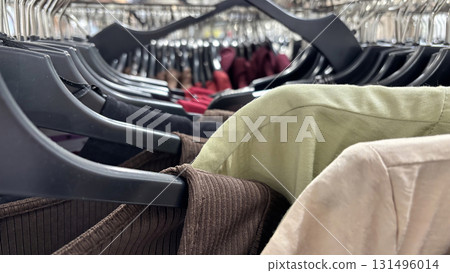 Various dresses on hangers in clothing store. Autumn and winter wardrobe preparation, seasonal fashion collection, modern apparel, stylish outfit shopping Various dresses on hangers in clothing store. Autumn and winter wardrobe preparation, seasonal fashion collection, modern apparel, stylish outfit shopping 131496014
