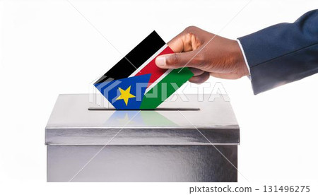 Hand voting ballot paper and ballot box with flag of South Sudan. Election. 131496275