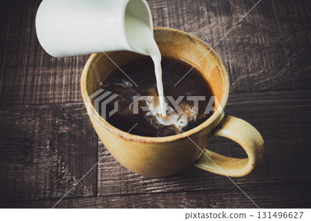 pouring milk into coffee pouring milk into coffee 131496627