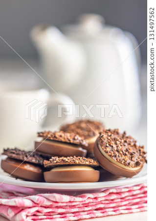 Sweet chocolate pralines. Chocolate candies on plate on checkered napkin. 131497562