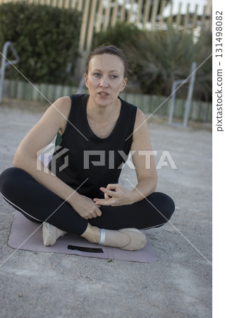 Woman meditating outdoors practicing yoga mudra hand gesture 131498082