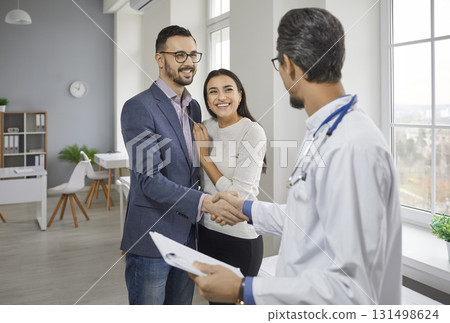 Happy couple meeting family doctor medical specialist in office Happy couple meeting family doctor medical specialist in office 131498624