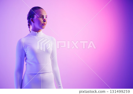 Woman in smartglasses standing against purple background 131499259