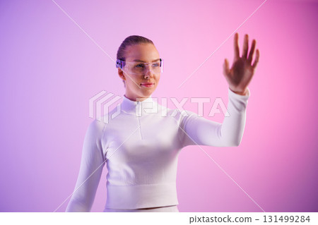 Female in smartglasses against colored background Female in smartglasses against colored background 131499284