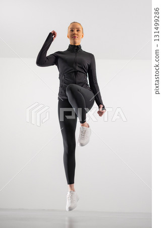 Woman performing a fitness exercise Woman performing a fitness exercise 131499286