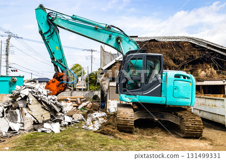 Old house demolition work - heavy machinery backhoe Old house demolition work - heavy machinery backhoe 131499331