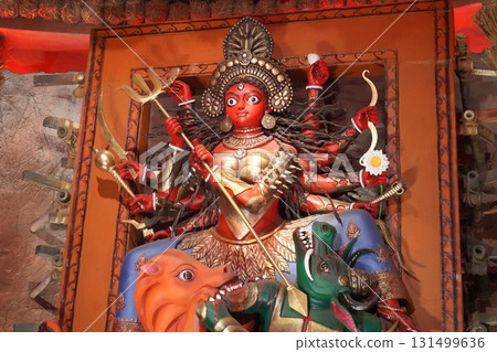 Goddess Durga with Red Face Slaying Mahishasura in Bengali Pandal during Puja Festival Goddess Durga with Red Face Slaying Mahishasura in Bengali Pandal during Puja Festival 131499636