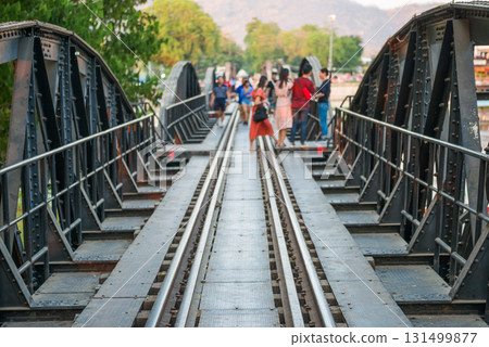 People walking by rail track of railroad bridge 131499877