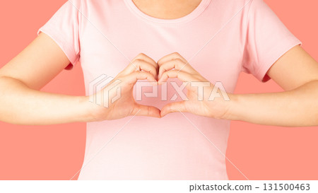 Breast Cancer Awareness in October. Woman hand made heart shape on her chest for support people who live with breast cancer. Women's health care concept. 131500463