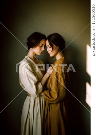 Two women are hugging each other in a room 131500530