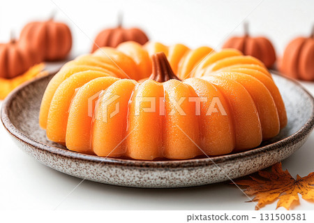 Delicious dessert. Pumpkin dessert in orange tones on a plate with soft lighting. Preparing for Halloween. Autumn atmosphere. Delicious dessert. Pumpkin dessert in orange tones on a plate with soft lighting. Preparing for Halloween. Autumn atmosphere. 131500581