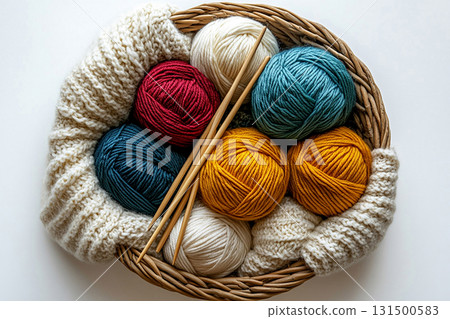 Ready to Create. Top view. Vibrant yarn skeins arranged neatly beside knitting needles. Ready to Create. Top view. Vibrant yarn skeins arranged neatly beside knitting needles. 131500583