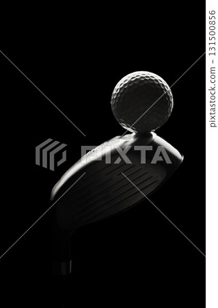 Golf ball balanced on metallic club head with artistic lighting 131500856