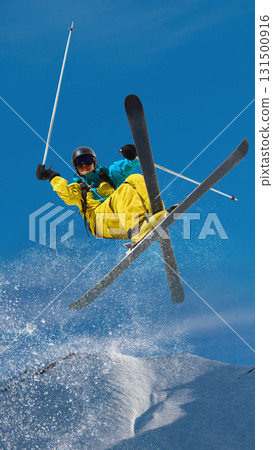 Male skier performing freestyle aerial jump with crossed skis in snow park Male skier performing freestyle aerial jump with crossed skis in snow park 131500916