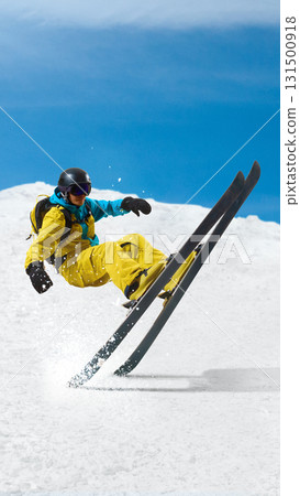 Male skier falling in dynamic crash on snowy slope with blue sky background Male skier falling in dynamic crash on snowy slope with blue sky background 131500918