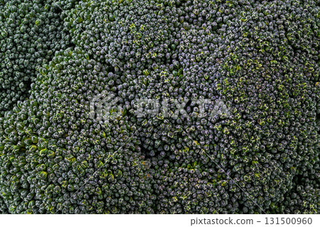 A close up of a bunch of broccoli with green leaves 131500960