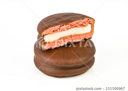 A chocolate cookie with a white filling is cut in half 131500967