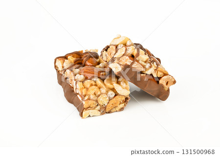 Two pieces of chocolate covered nuts are on a white background 131500968