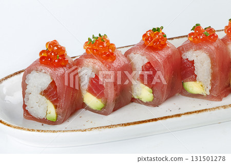Ceramic tray with variety of tuna sushi roll with avocado, appetizing japanese meal. Ceramic tray with variety of tuna sushi roll with avocado, appetizing japanese meal. 131501278