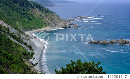 An expansive, elevated landscape os Asturias, Spain, photograph capturing a dramatic, rugged coastline on an overcast day.  131501347