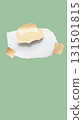 Torn piece of school notebook in a grid and brown piece of paper with beige tape on green background 131501815