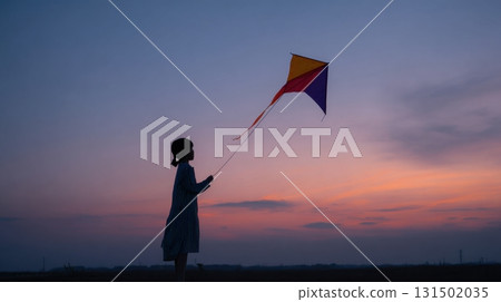 Silhouette Of A Child Flying A Colorful Kite At Sunset. Capturing The Joy And Freedom Of Outdoor Play Silhouette Of A Child Flying A Colorful Kite At Sunset. Capturing The Joy And Freedom Of Outdoor Play 131502035