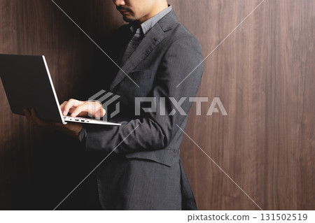 A man who operates a laptop computer A man who operates a laptop computer 131502519
