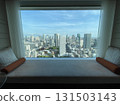 Hotel sofa, cityscape seen from the window 131503143