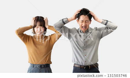 Two businessmen, male and female, holding their heads and worrying 131503746
