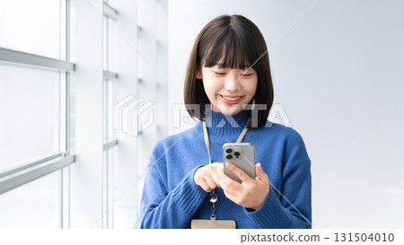 Smiling woman/businesswoman using a smartphone Smiling woman/businesswoman using a smartphone 131504010
