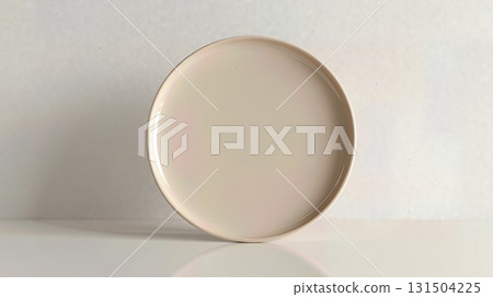 Minimalist beige ceramic plate on a clean bright background. Minimalist beige ceramic plate on a clean bright background. 131504225