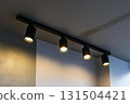 Lighting equipment on the wall in the living room. Spotlights under the ceiling. Track LED-lighting system 131504421