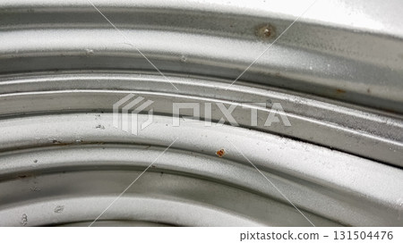 A zoomed-in photo shows a tight corner of a window well where corrugated metal sheets meet. The materials reflect light in clean arcs and show slight imperfections. A zoomed-in photo shows a tight corner of a window well where corrugated metal sheets meet. The materials reflect light in clean arcs and show slight imperfections. 131504476